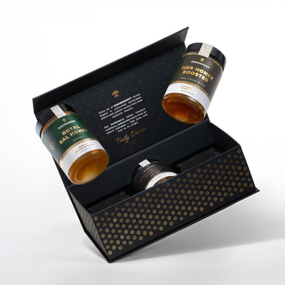A black gift box containing three small jars of honey products, photographed on a clean white background. The open box is angled to show the interior and the branded jars, which include one Sal honey-labeled jar, one Sidr/golden-labeled jar, and one partially visible dark jar.
