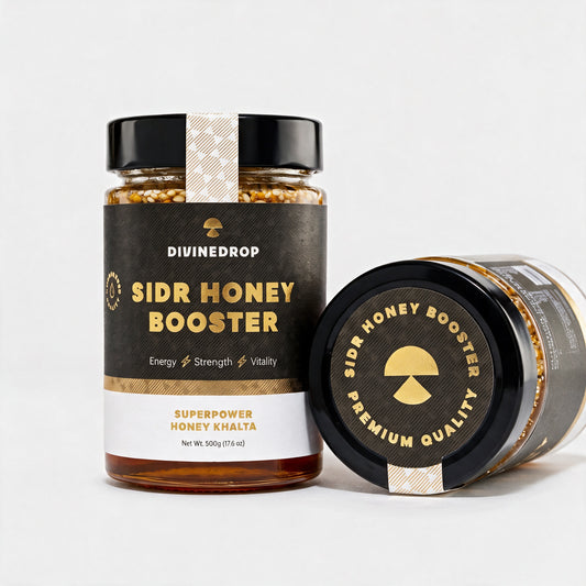 Two DIVINEDROP Sidr Honey Booster jars, one upright and one on its side showing the gold Premium Quality lid